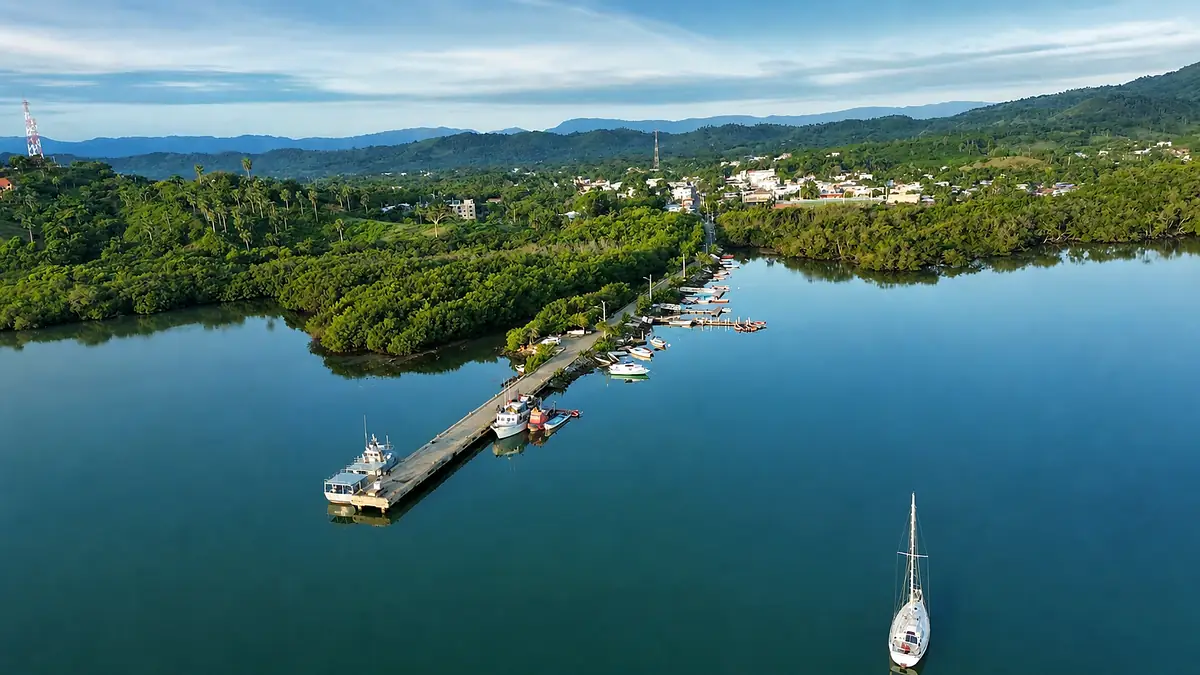 Aerial view of mangrove-lined waters and shoreline near Luperón harbor.